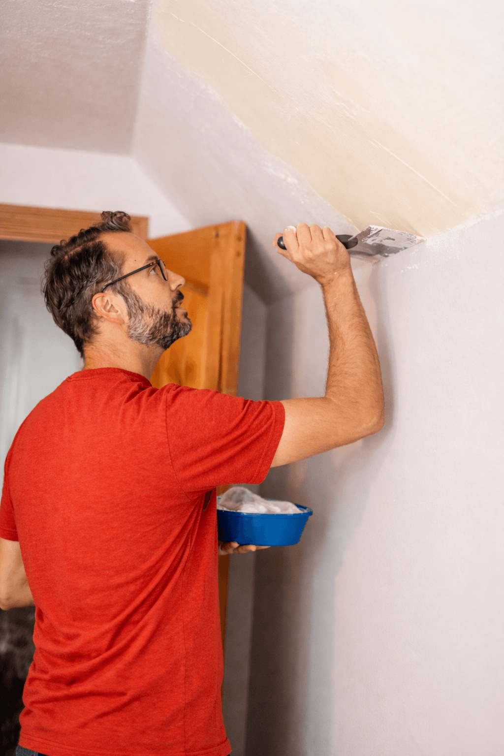 Close-up of plaster being smoothed onto a wall